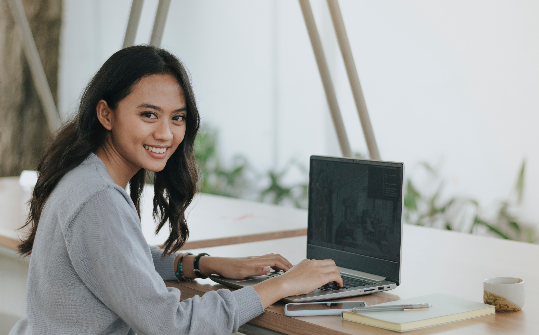 Smiling Woman Using Her Laptop Outdoors