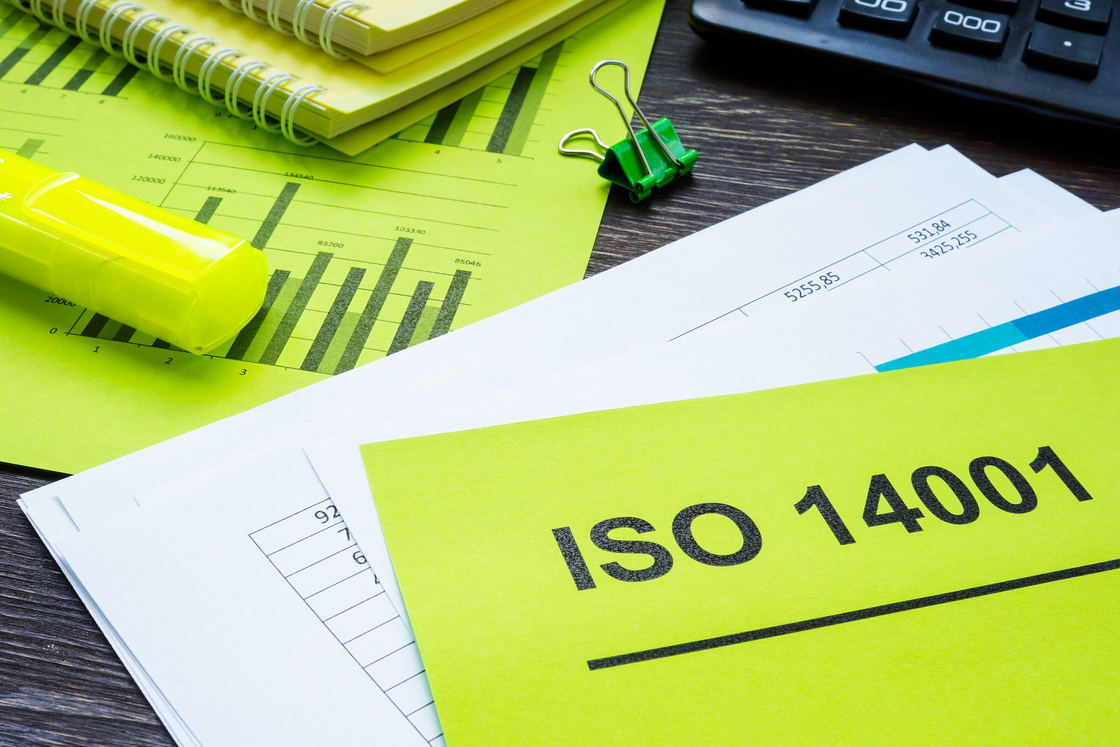 Stack of papers about ISO 14001 in the office.
